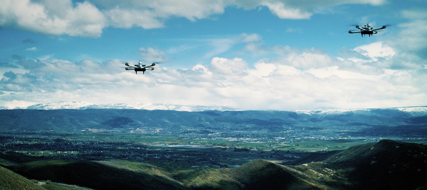 A cloud-seeding drone in the sky over a city