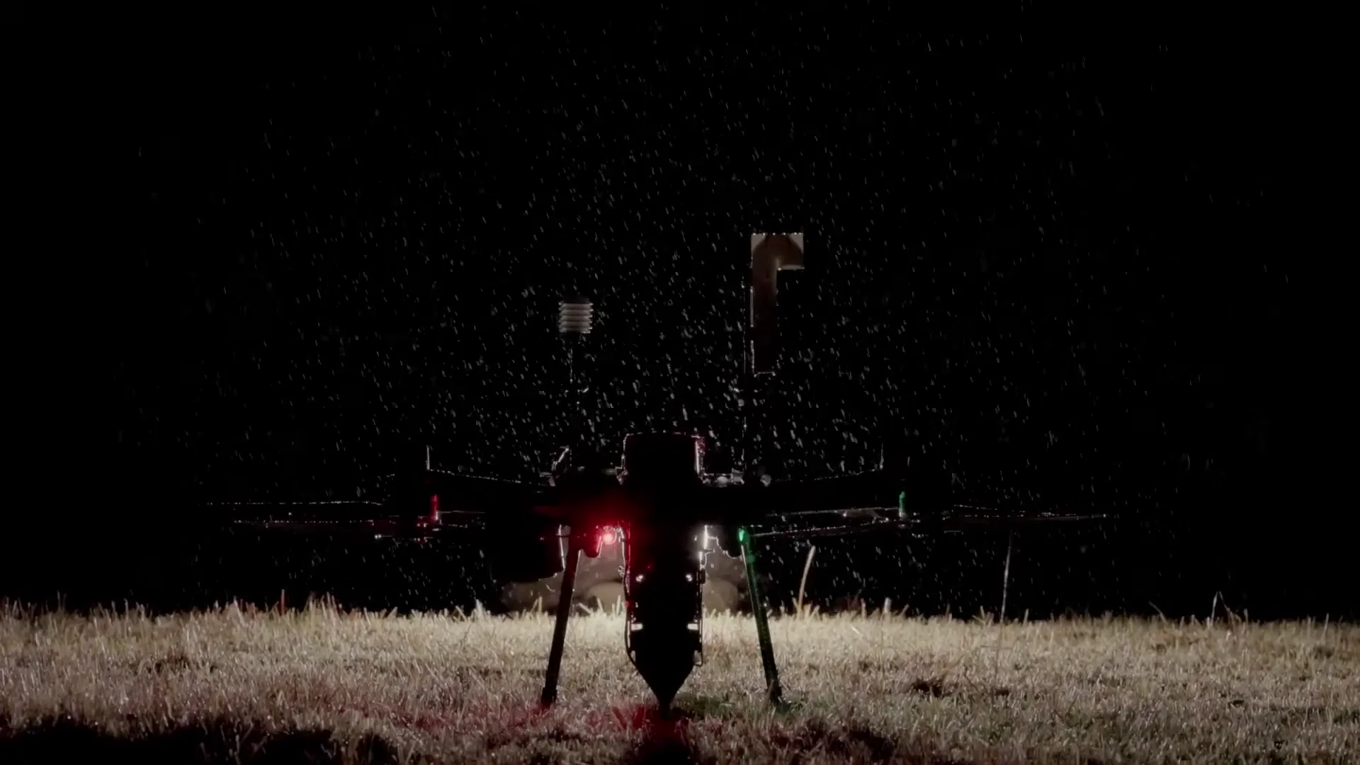 A Rainmaker drone operating over a field at night